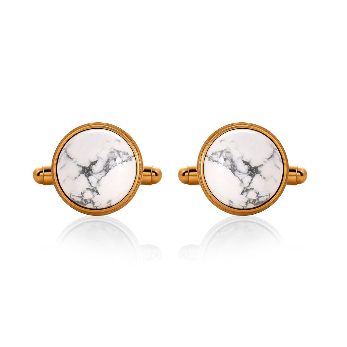 Pair of cufflinks with gold frames and white marbled centers on a white background