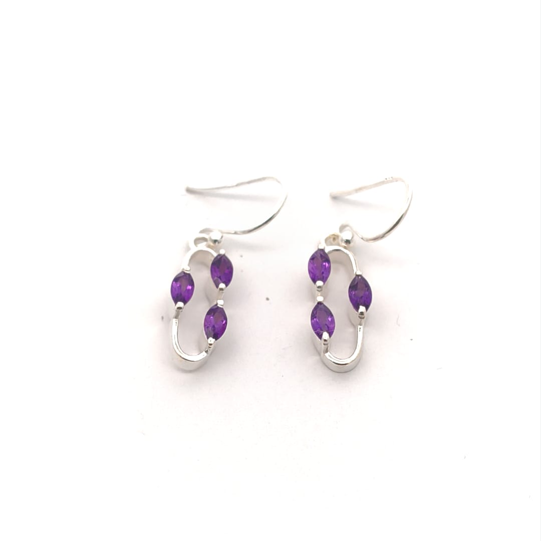 Silver earrings with purple beads on a white background