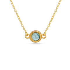 Gold necklace with a round gemstone pendant on a white background