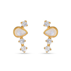 Gold earrings with clear gemstones on a white background