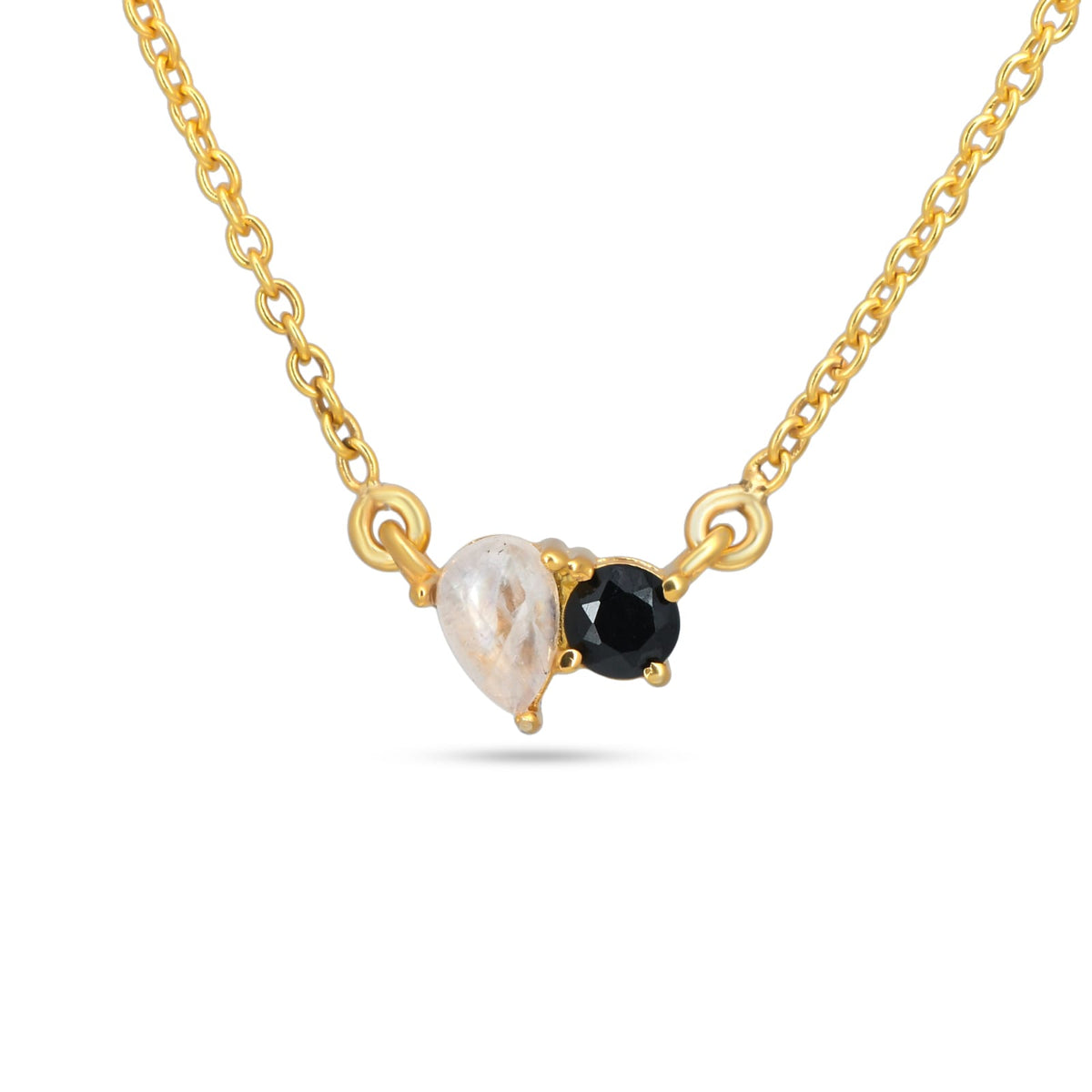 Gold necklace with a black gemstone and a pearl on a white background