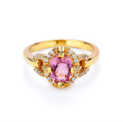 Gold ring with a pink gemstone on a white background