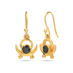 Gold earrings with black gemstones on a white background