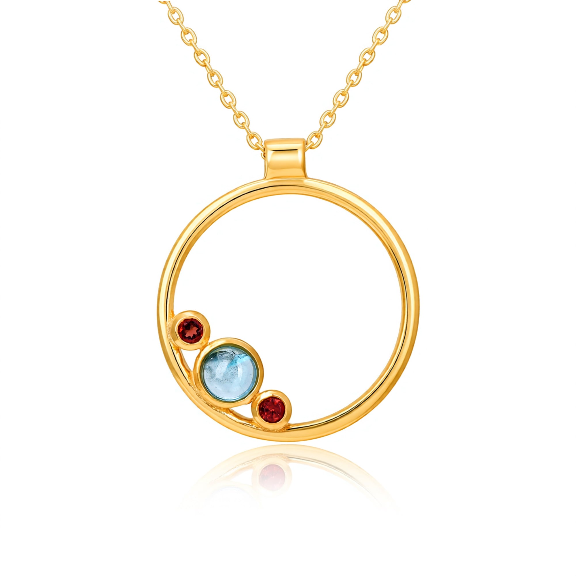 Gold necklace with a circular pendant featuring three colored stones on a white background