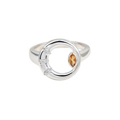 Silver ring with a central brown gemstone and smaller clear stones on a white background