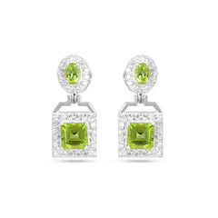 Pair of earrings with green gemstones on a white background