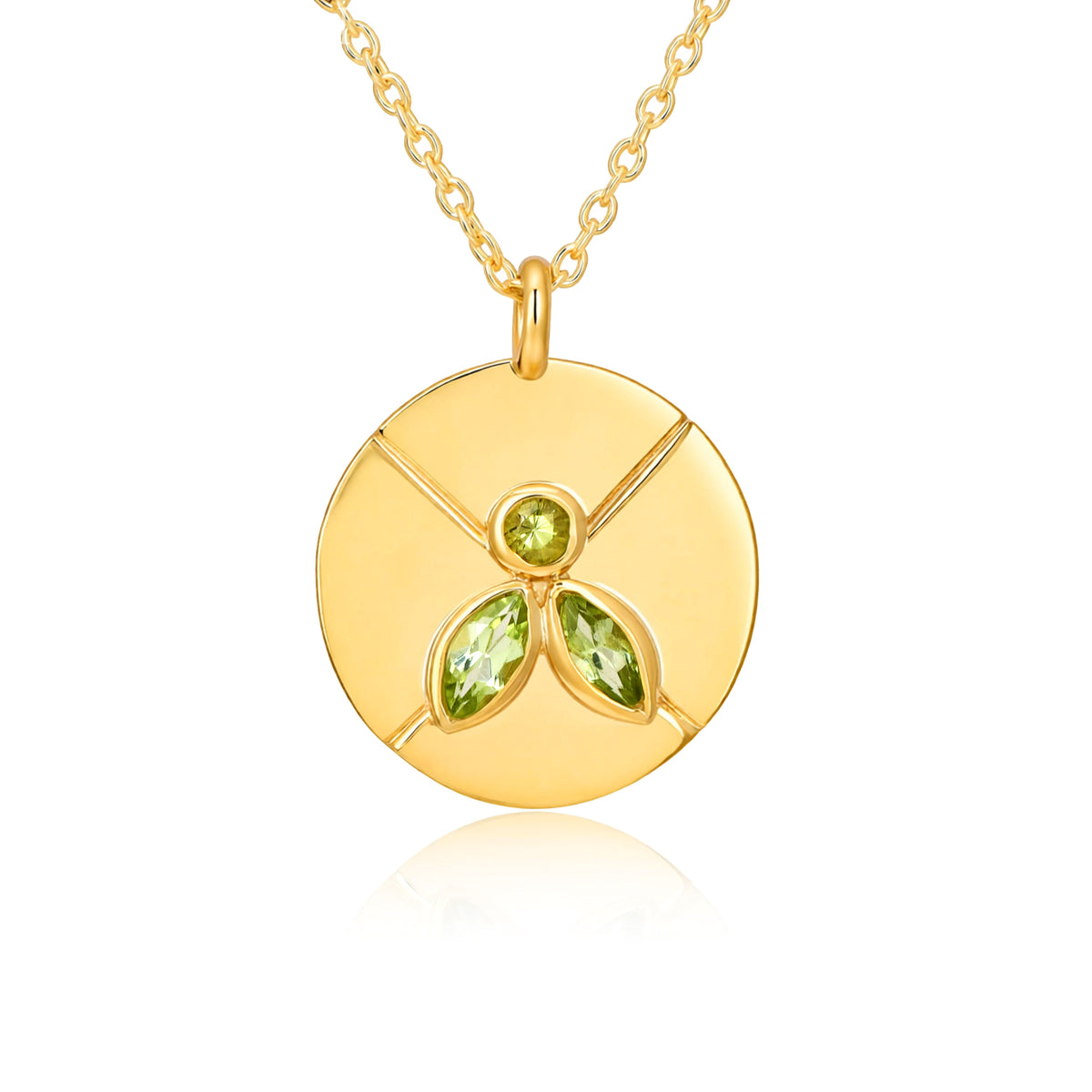 Gold necklace with a circular pendant featuring green gemstones on a white background