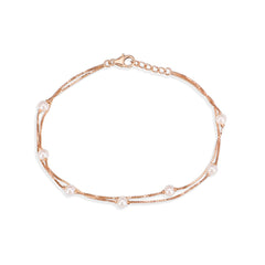 Rose gold bracelet with pearls on a white background