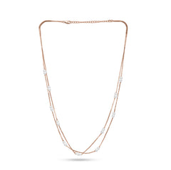 Long necklace with rose gold chain and pearls on a white background