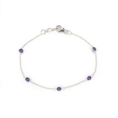 Silver bracelet with purple gemstones on a white background