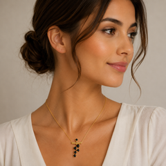 Woman wearing a gold necklace with a neutral background