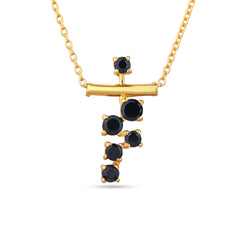 Gold necklace with black gemstones on a white background