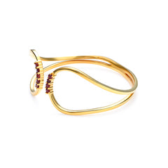 Gold bracelet with red gemstones on a white background