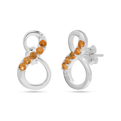 Silver earrings with orange gemstones on a white background