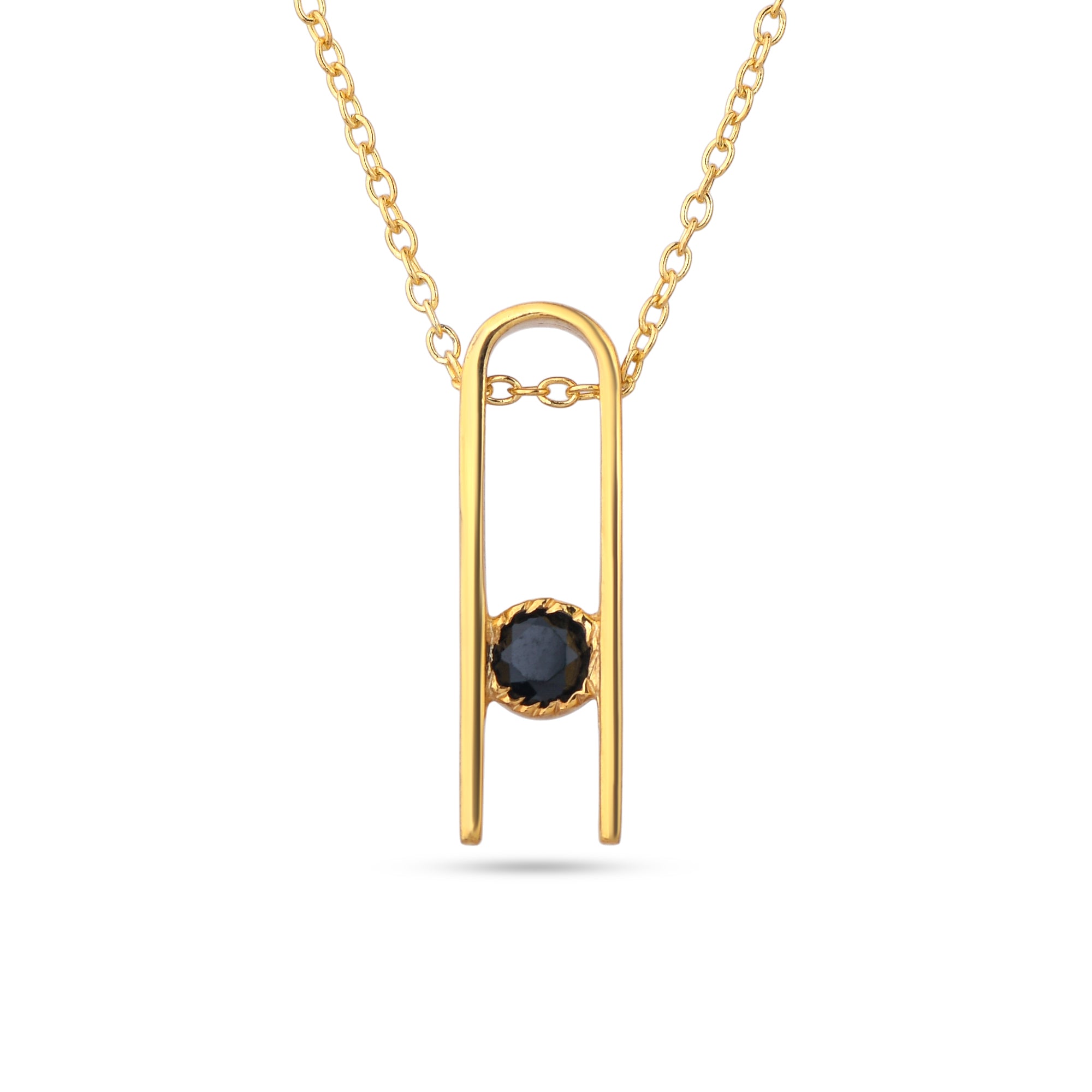 Gold necklace with a black gemstone pendant on a white background