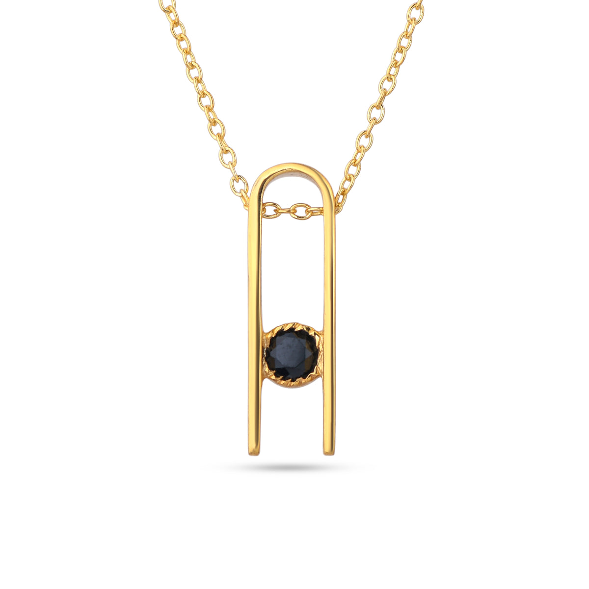 Gold necklace with a black gemstone pendant on a white background
