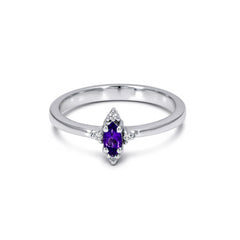 Silver ring with a purple gemstone on a white background