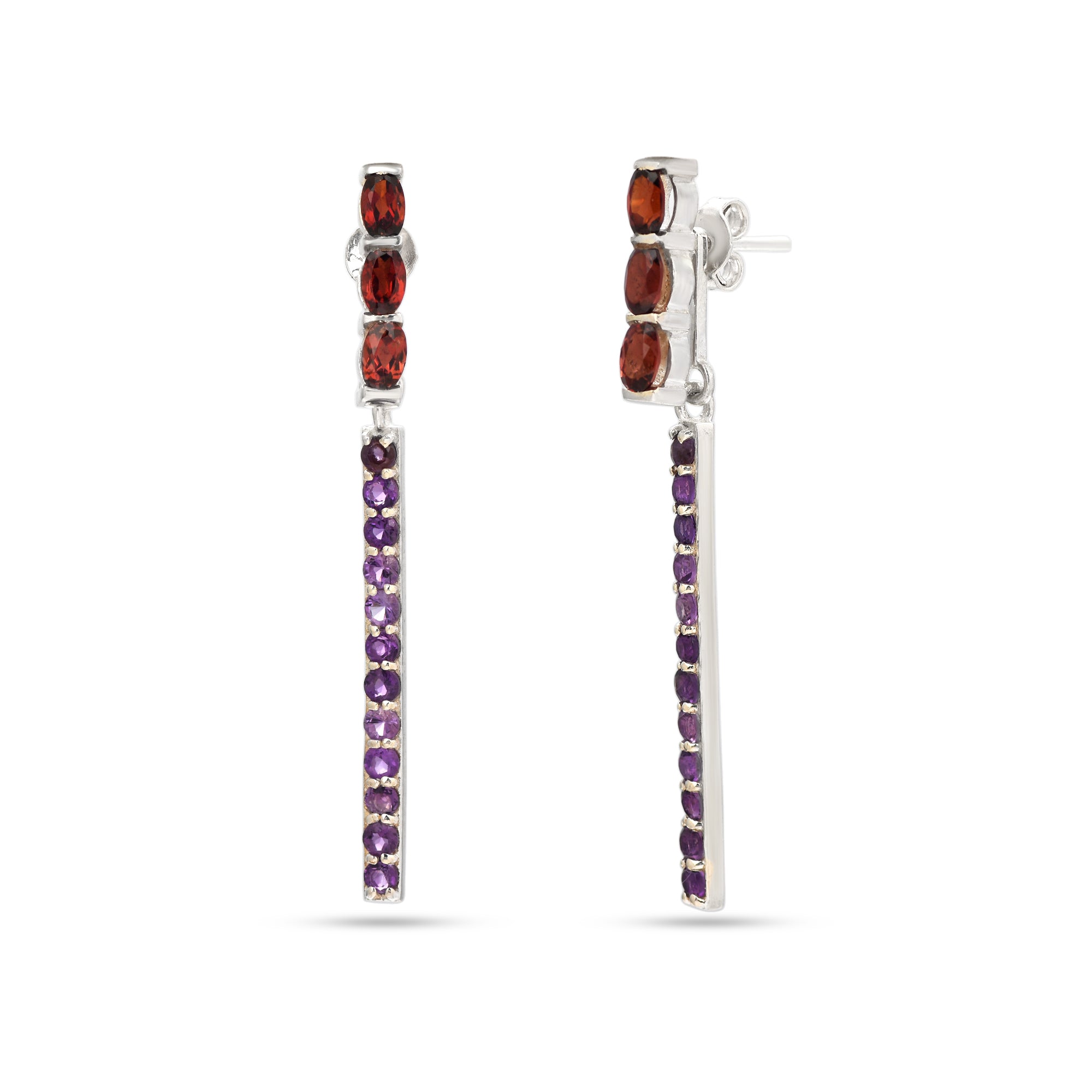 Pair of earrings with red and purple gemstones on a white background