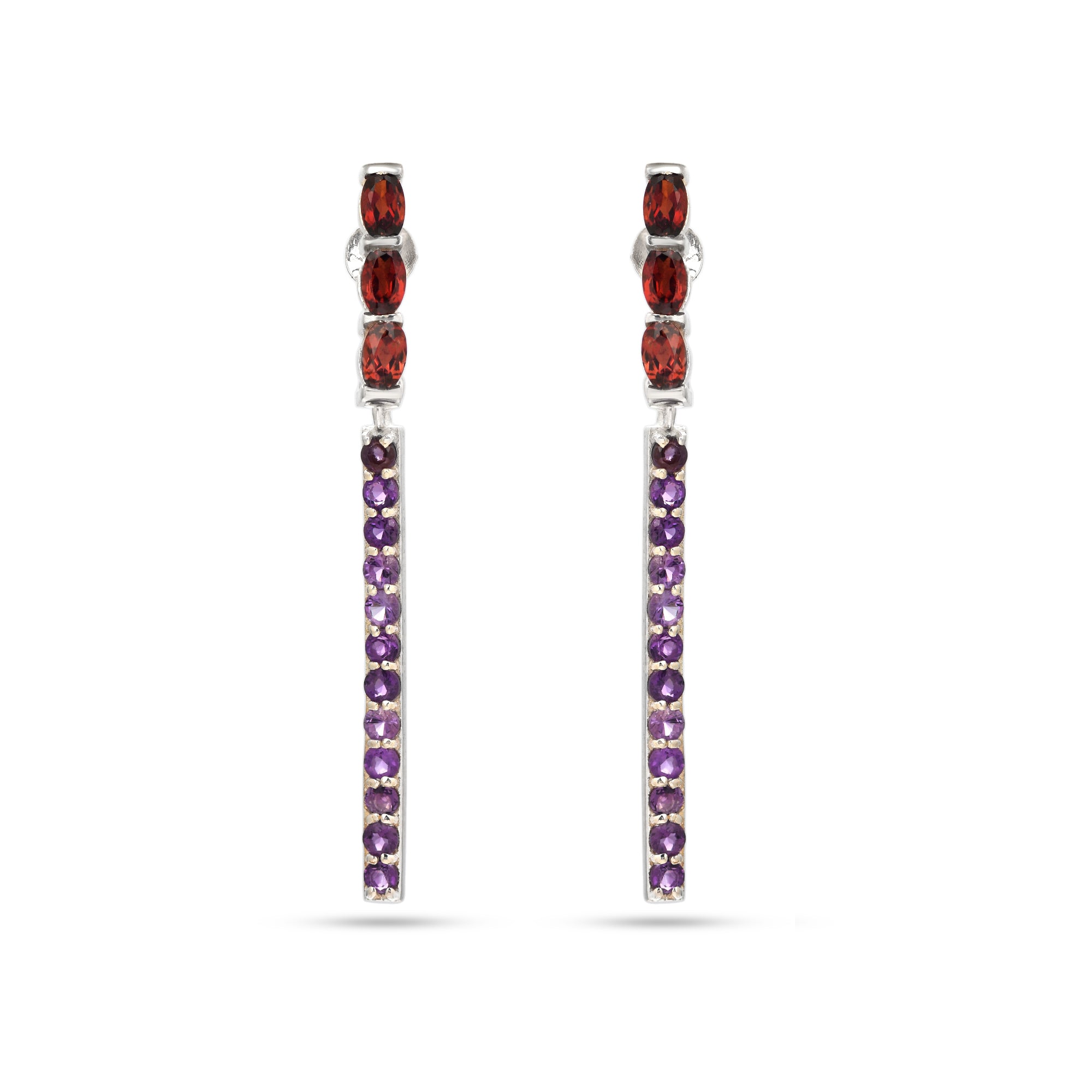 Pair of earrings with red and purple gemstones on a white background