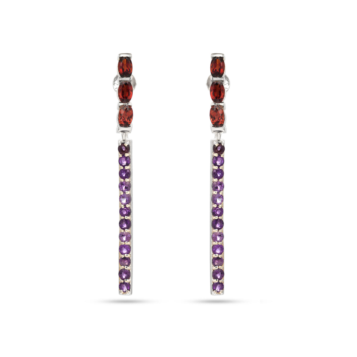 Pair of earrings with red and purple gemstones on a white background