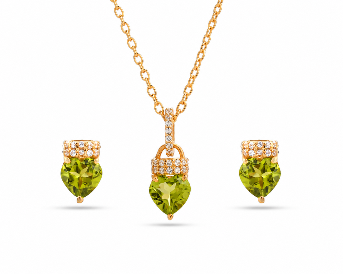 Gold necklace with heart-shaped green gemstones on a white background