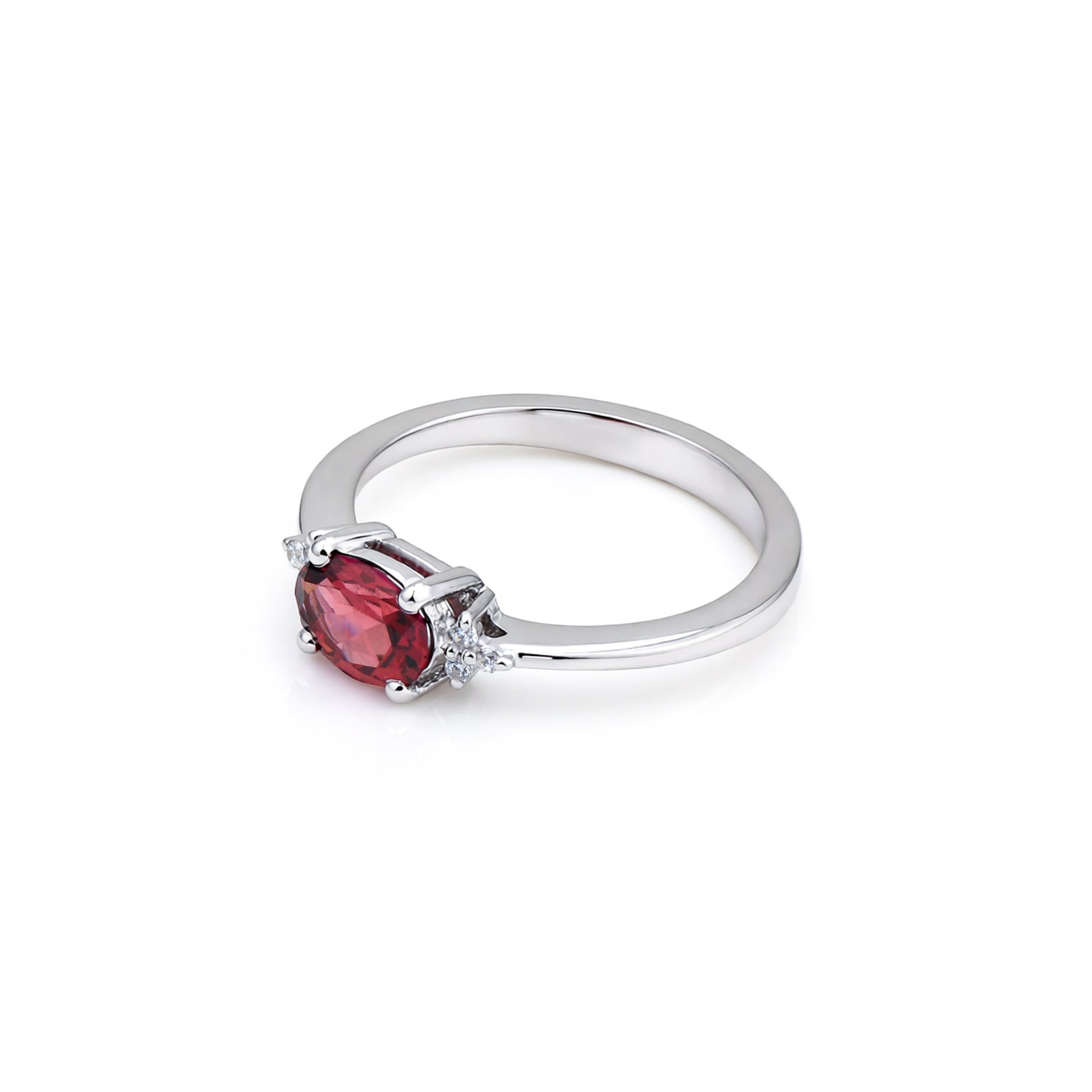 Silver ring with a red gemstone on a white background