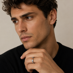 Man wearing a black sweater with a neutral background