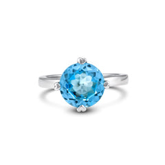 Silver ring with a blue gemstone on a white background